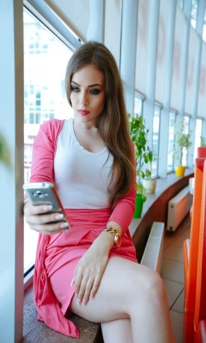 Smiling escort relaxing on a sofa